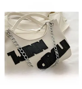 Detail of white PU leather tote with black CIRCLE lettering and silver metal chain