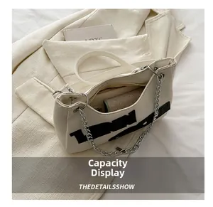 Internal view of a white chain shoulder bag showing capacity for a phone and wallet