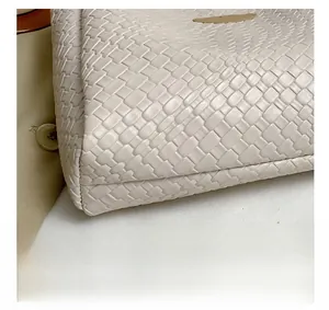 Close-up of the intricate woven texture and craftsmanship on a beige tote bag