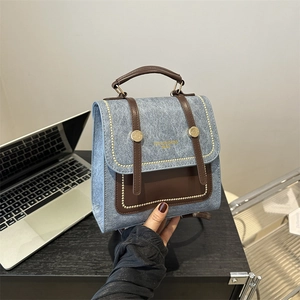 Retro light blue denim and brown leather mini backpack with gold rivets and handle