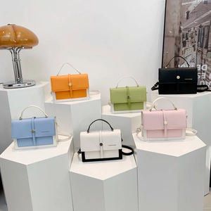 Stylish candy-colored PU leather crossbody bags in diverse colors on geometric stands