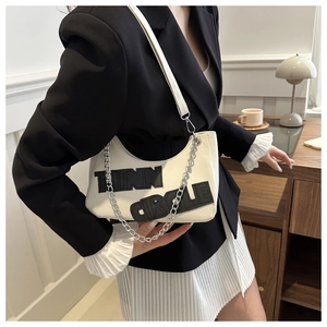 Detail of off-white crescent bag with TINN CIRCLE embroidery and silver chain strap