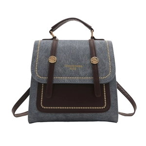 Vintage denim and leather backpack with gold rivets and top handle for women
