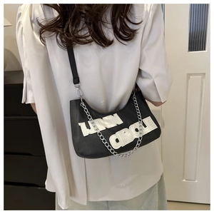 Detail of black hobo bag with white Linn Circle lettering and silver metal chain strap