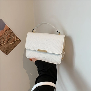 Chic white embossed leather top-handle bag with gold accents and a minimalist design