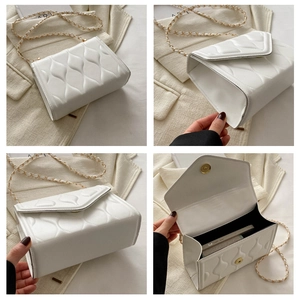 Detail view of white quilted chain bag showing interior space and gold hardware texture