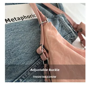 Detail view of pink marble-textured bag featuring an adjustable silver buckle and chain