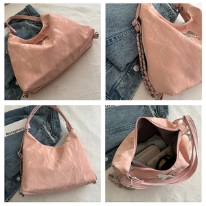 Detailed views of pink crossbody bag with pleated texture, silver chain, and large capacity