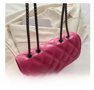 Detail of pink quilted chain bag showing metal eyelets and premium stitching texture