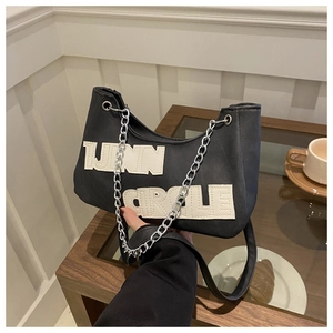 Detail of black canvas Hobo bag with TNN CIRCLE embroidery and silver chain strap
