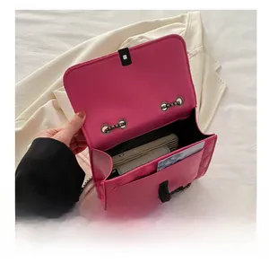 Macro view of magenta quilted chain bag showing interior compartment and turn-lock