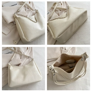 Detail view of large capacity beige pleated PU shoulder bag with chain strap