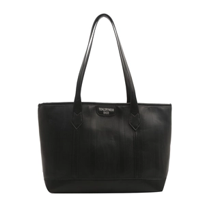 Minimalist black tote bag with vertical texture and leather handles for daily commute