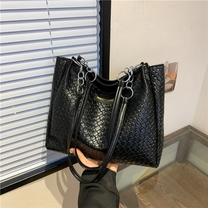 Black woven leather tote bag with silver chain straps and large capacity for commuting