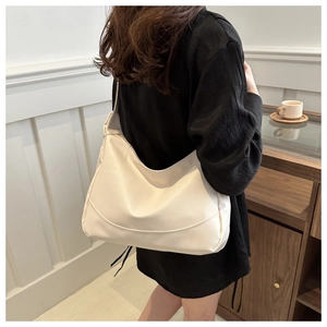 Cream-colored smooth PU leather hobo bag with a wide shoulder strap for daily commuting