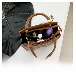Top view of brown quilted tote bag showing spacious interior with cosmetics and silk scarf