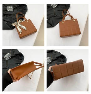 Detail view of brown quilted tote bag showing textures, gold chain strap and silk scarf
