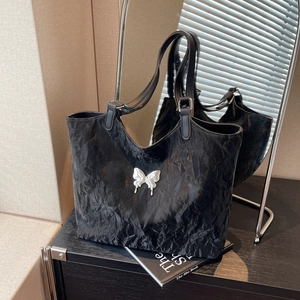 Large black crinkled tote bag with white butterfly logo for commute and school use
