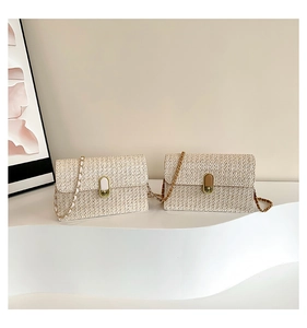 Detail of woven straw crossbody bags with metal twist locks and chain straps