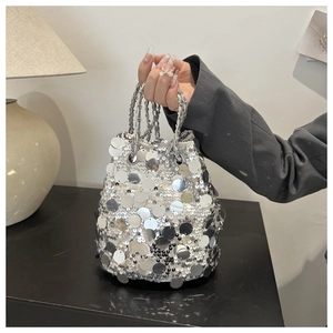 Makro-Detail der silbernen Pailletten-Beuteltasche mit metallischem Kettenhenkel