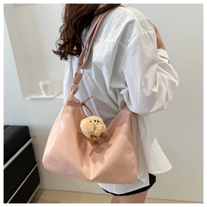 Detailed side view of pink large-capacity tote bag with a brown plush bear charm