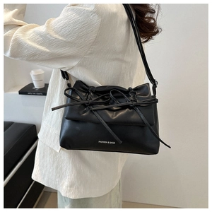 Detail of black crossbody bag with knotted bow pleats and Fashion & Bags text logo