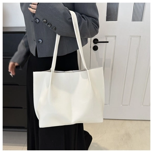 Minimalist large white PU leather tote bag shown on shoulder for sizing and fit