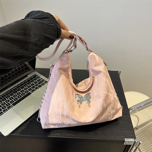 Pink pleated crossbody bag with silver butterfly charm and chain strap