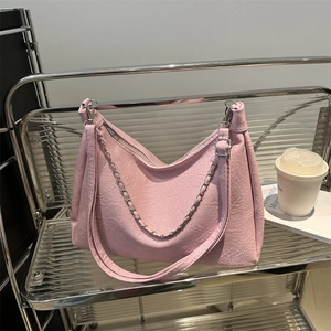 Large pale pink chain shoulder bag with pleated texture and stylish wide strap