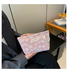 Pink heart canvas makeup bag with elegant pearl handle and fashion label detail