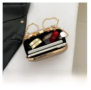 Macro detail of champagne gold sequin clutch bag showing large capacity for essentials