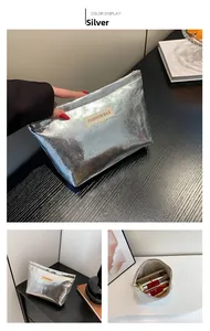 Detailed view of silver cosmetic bag showing interior space for lipsticks and phone