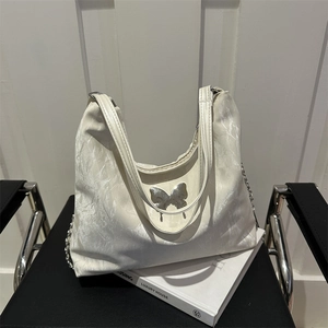 Cream white shoulder bag with marble texture and silver butterfly accent on book