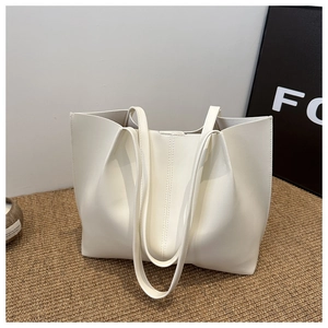 Close-up of cream white PU leather tote bag with elegant vertical stitching details