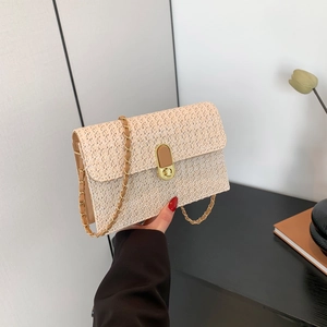 Straw crossbody bag with contrast brown leather strap and gold chain for summer style