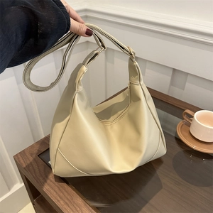 Chic beige half-moon hobo bag with gold zipper and adjustable strap for women