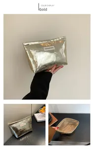 Detail view of golden metallic makeup bag with zipper and Fashion Bag label