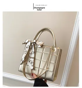 Champagne quilted PU leather handbag featuring a silk scarf handle and gold chain strap