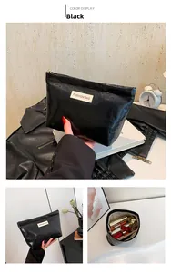 Detailed interior view of the large capacity black cosmetic bag showing ample storage space