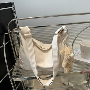 Minimalist cream white shoulder bag in smooth PU leather with cute bear charm detail