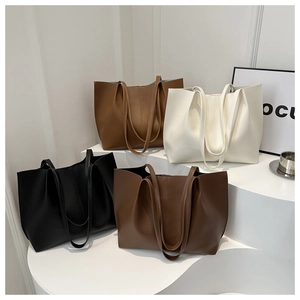 Minimalist large PU leather tote bags in four colors on an elegant geometric display