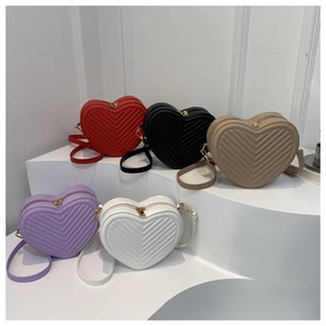 Detailed view of heart-shaped crossbody bags in five colors with V-quilted texture