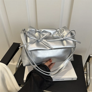 Silver metallic leather shoulder bag with bow details and soft pleated design for women