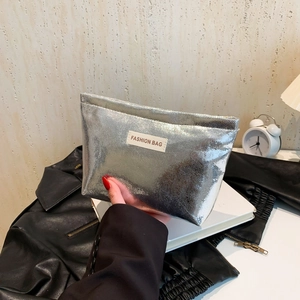 Silver snakeskin texture makeup bag with Fashion Bag label held against lifestyle background