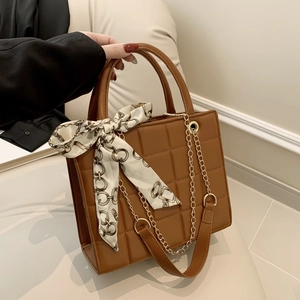 Brown quilted faux leather tote bag with chain strap and elegant decorative scarf