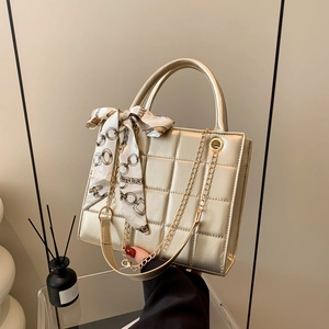 Fashionable champagne gold quilted tote bag with chain strap and decorative silk scarf