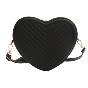 Minimalist heart-shaped crossbody bag with black chevron quilting and gold metal hardware