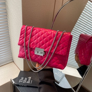 Hot pink quilted chain crossbody bag with silver hardware and turn-lock closure