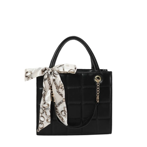 Fashionable black quilted tote bag with elegant silk scarf detail and golden chain accessory