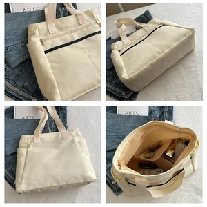 Dettagli della borsa tote in tela beige con scomparti interni e cerniere metalliche